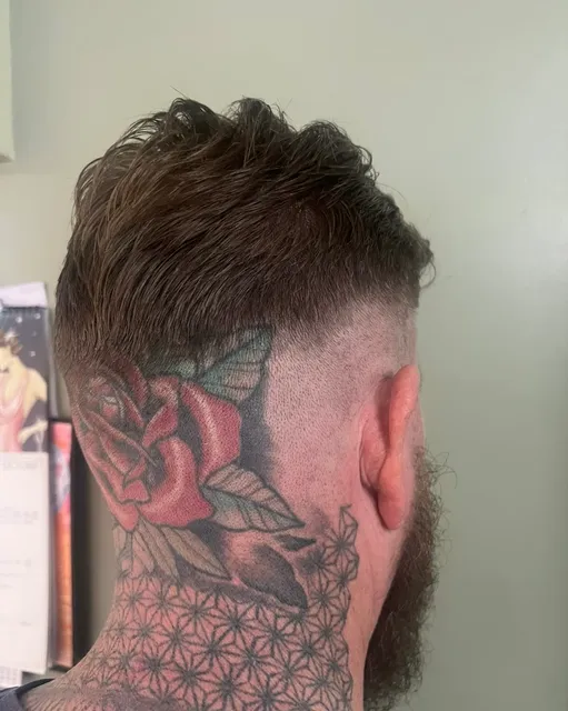 Men's skin fade with a longer textured top swept back